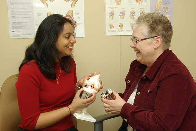 Advanced Physiotherpist Practitioner talking with patient 
